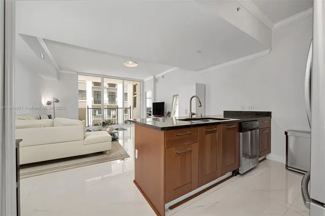 a kitchen with stainless steel appliances granite countertop a stove a sink and a refrigerator