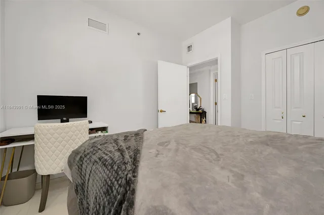 a bed room with a bed and a television