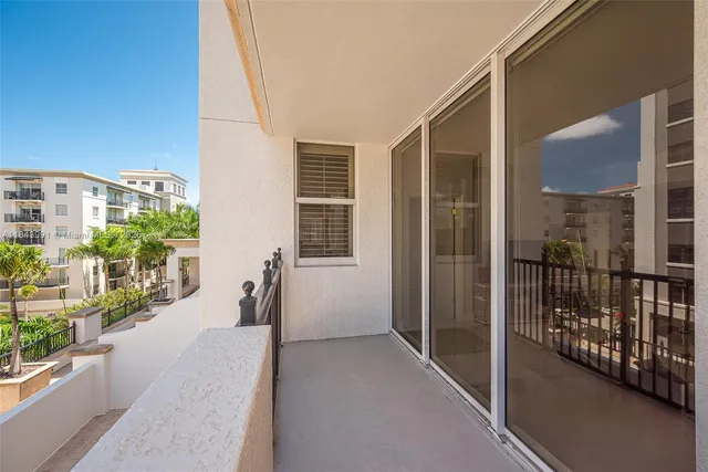 a view of a balcony with potted plants