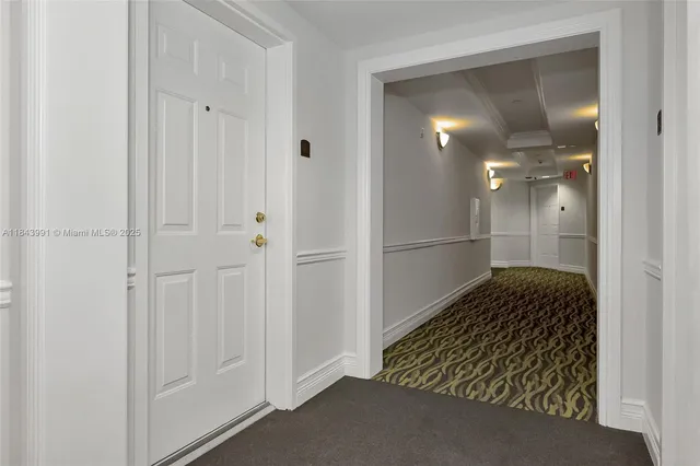 a view of a hallway with wooden cabinets