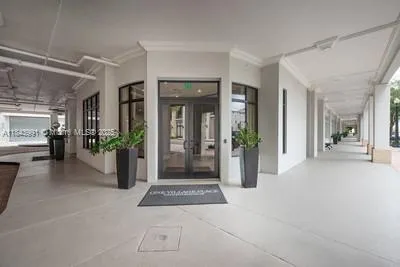 a view of a hallway with dining area and chandelier