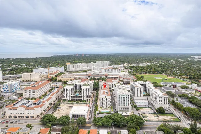 an aerial view of residential building with yard and ocean view