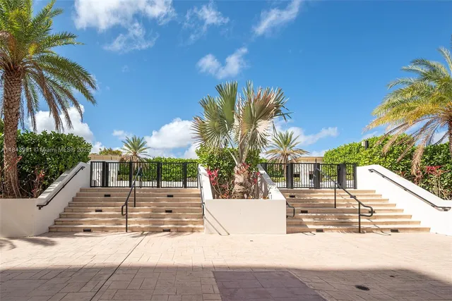 a view of a white house with a yard