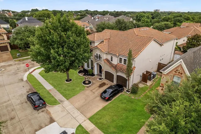 an aerial view of a house with yard and furniture