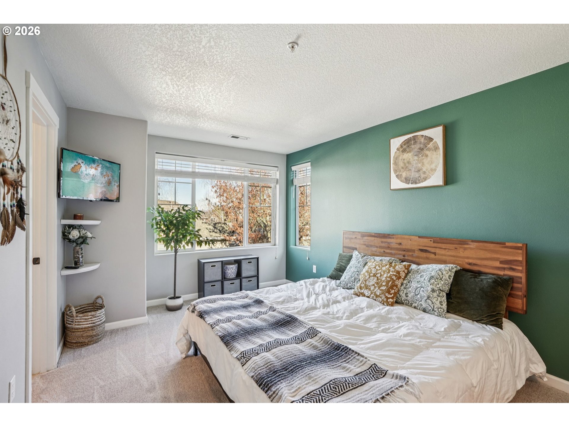 10739 Southwest Canterbury Lane, Unit 101 Portland, OR 97224 - Photo 12 of 27 a bedroom with a bed and a window