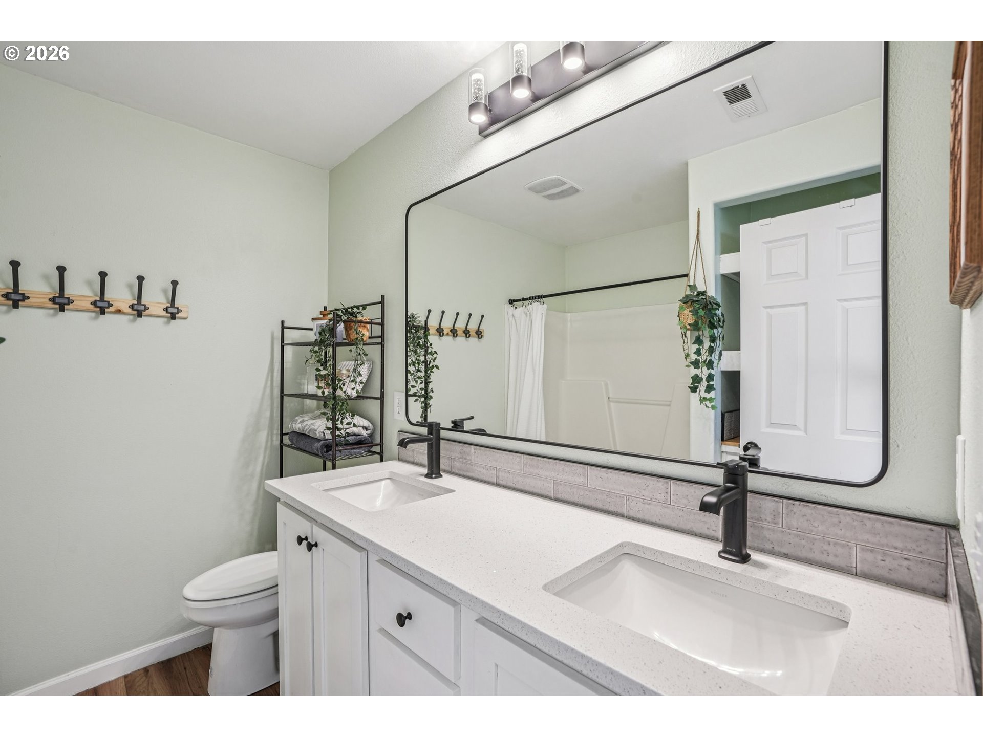 10739 Southwest Canterbury Lane, Unit 101 Portland, OR 97224 - Photo 15 of 27 a bathroom with a sink a toilet and a mirror