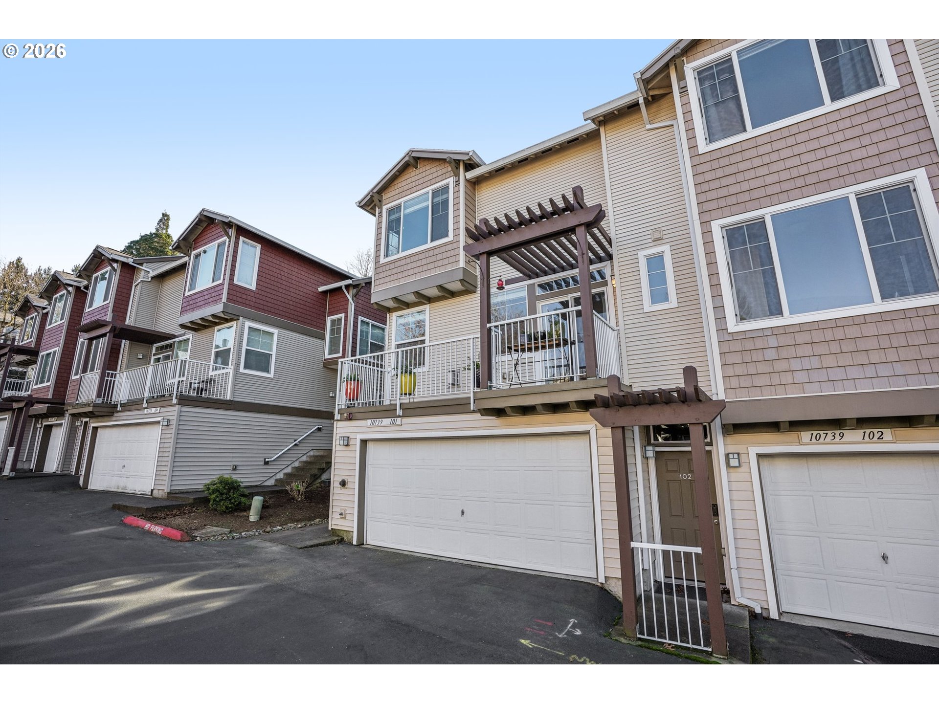 10739 Southwest Canterbury Lane, Unit 101 Portland, OR 97224 - Photo 3 of 27 a view of a big house with many windows