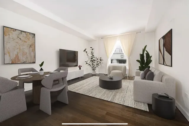 a living room with furniture a flat screen tv and a window