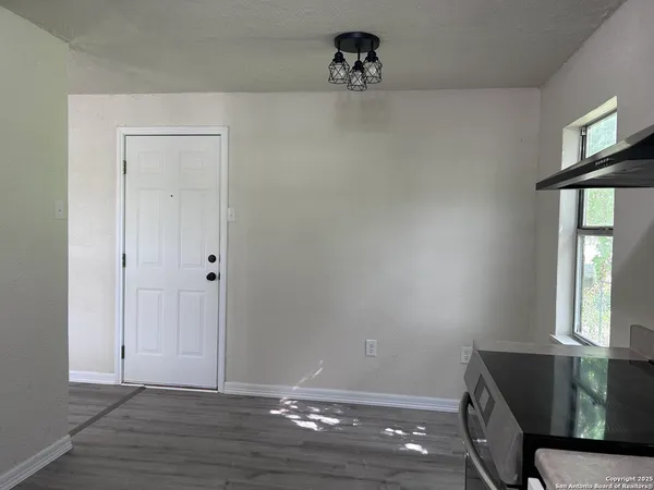 a view of room with window and wooden floor