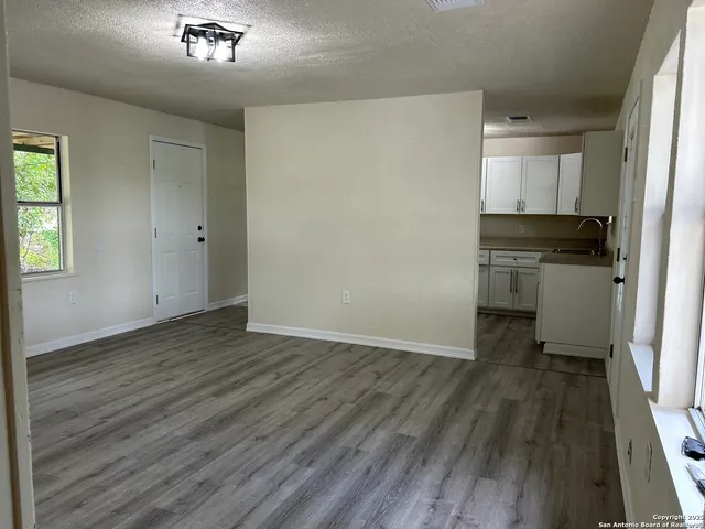 a view of a kitchen from a hallway