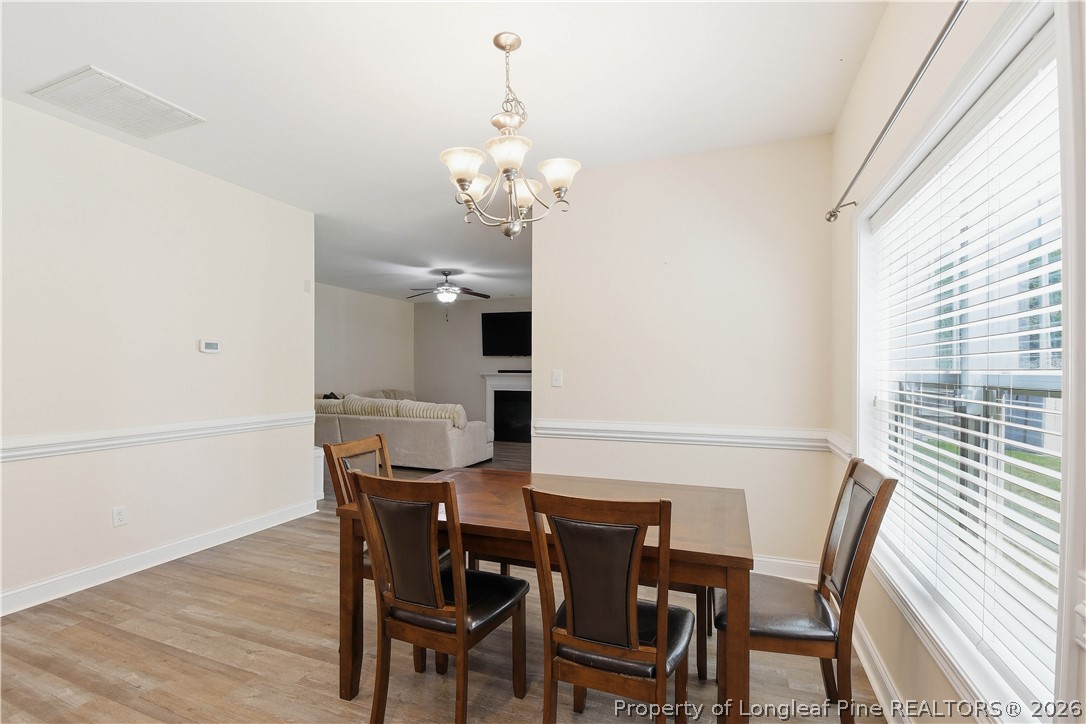 140 Birch Avenue Spring Lake, NC 28390 - Photo 22 of 49 a view of a dining room with furniture and wooden floor