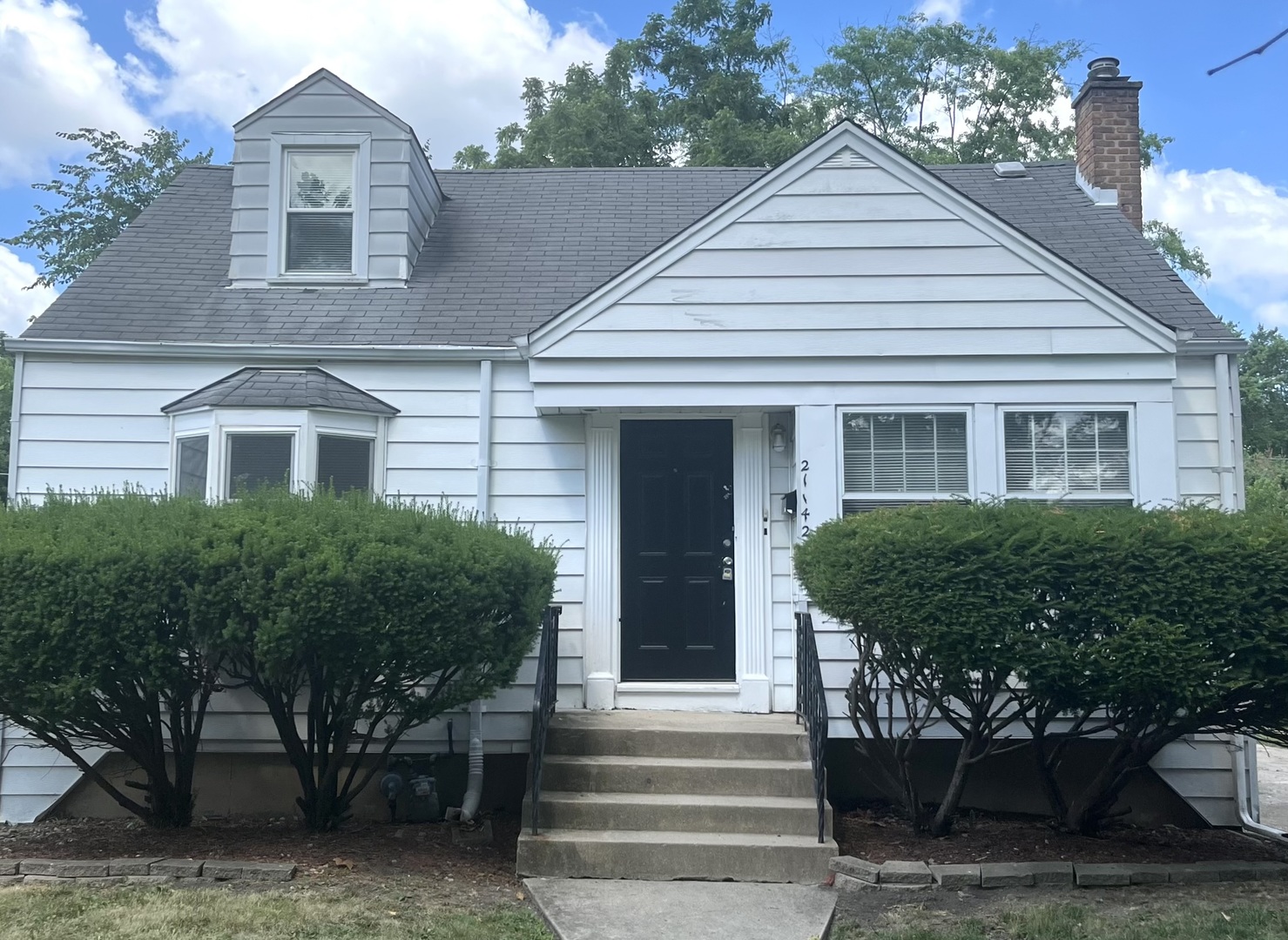 21142 Locust Street Matteson, IL 60443 - Photo 1 of 18 a front view of a house with a garden