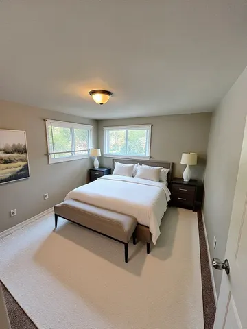 a spacious bedroom with a bed and window