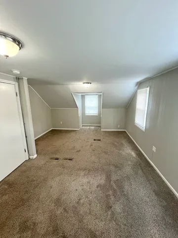 an empty room with a empty space and windows