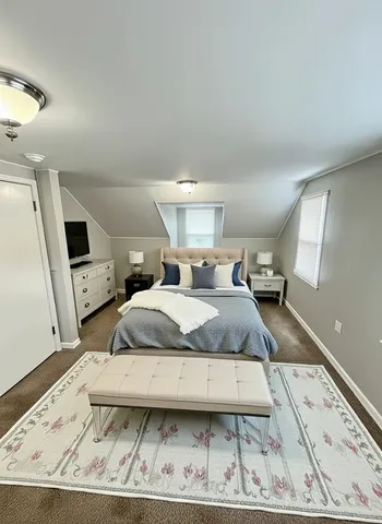 a bedroom with a bed and a large mirror