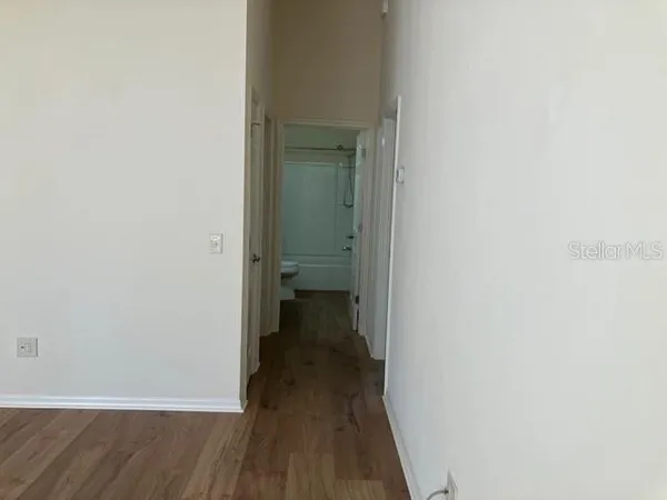 a view of a room with wooden floor