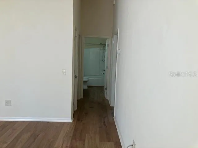 a view of a room with wooden floor