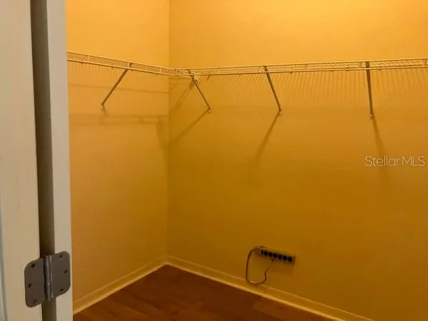 a view of a room with wooden floor