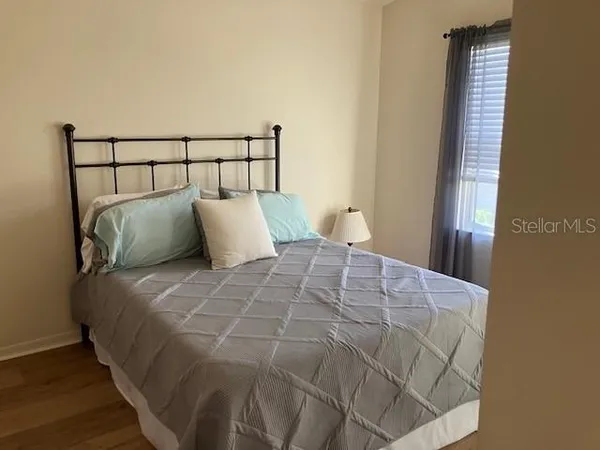 a large bed sitting in a bedroom next to a window