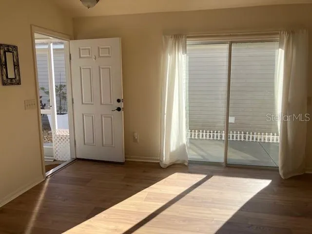 a view of a bedroom with wooden floor