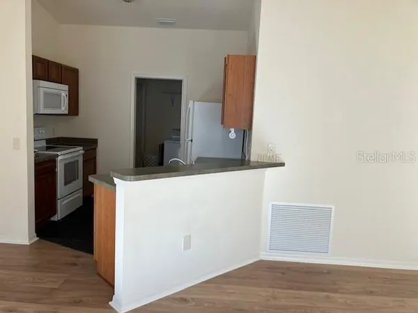 a kitchen with a refrigerator and a stove