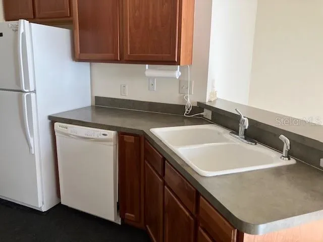 a kitchen with a sink and a refrigerator