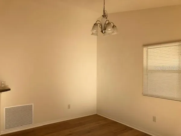 a view of a room with wooden floor and windows