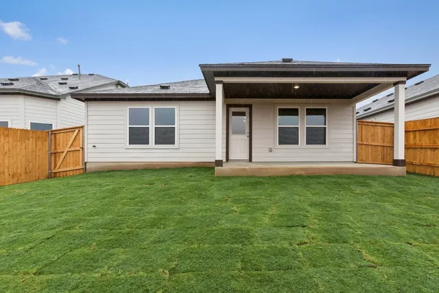 a view of a house with a backyard