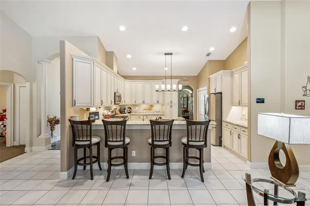 a large kitchen with a table and chairs