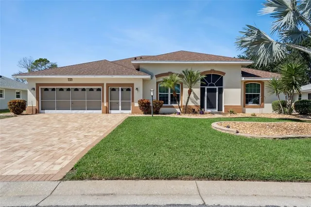 a view of a house with a swimming pool and a yard