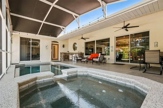 a view of a swimming pool with outdoor seating