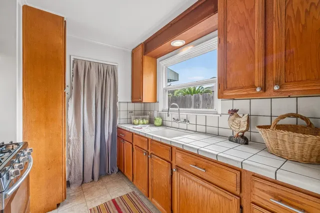 a kitchen with stainless steel appliances granite countertop a sink stove and cabinets