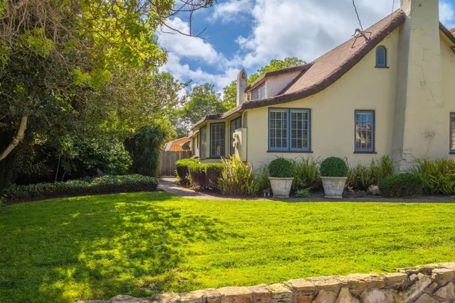 a view of a house with a yard patio and swimming pool