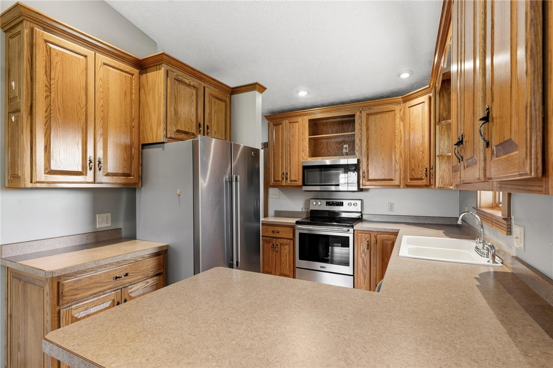 4971 Lackey Road Cedarville, OH 45314 - Photo 52 of 79 This spacious kitchen offers ample cabinetry, modern stainless steel appliances, and abundant counter space.