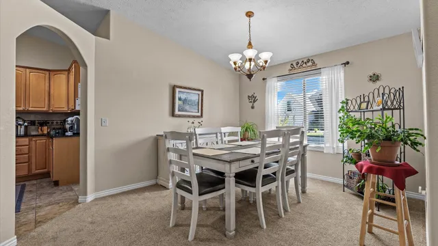 a view of a dining room with furniture and chandelier