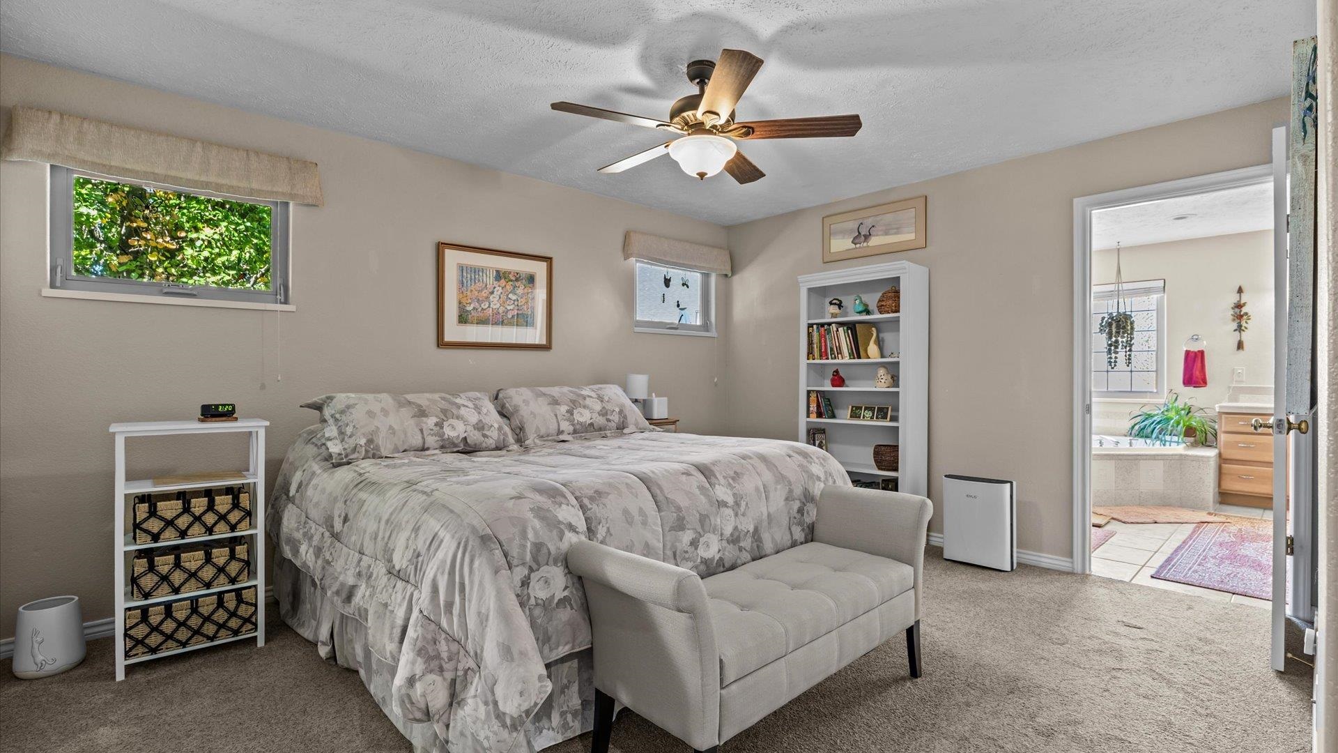 1355 Monument Court Fruita, CO 81521 - Photo 12 of 27 a spacious bedroom with a bed and a cabinets