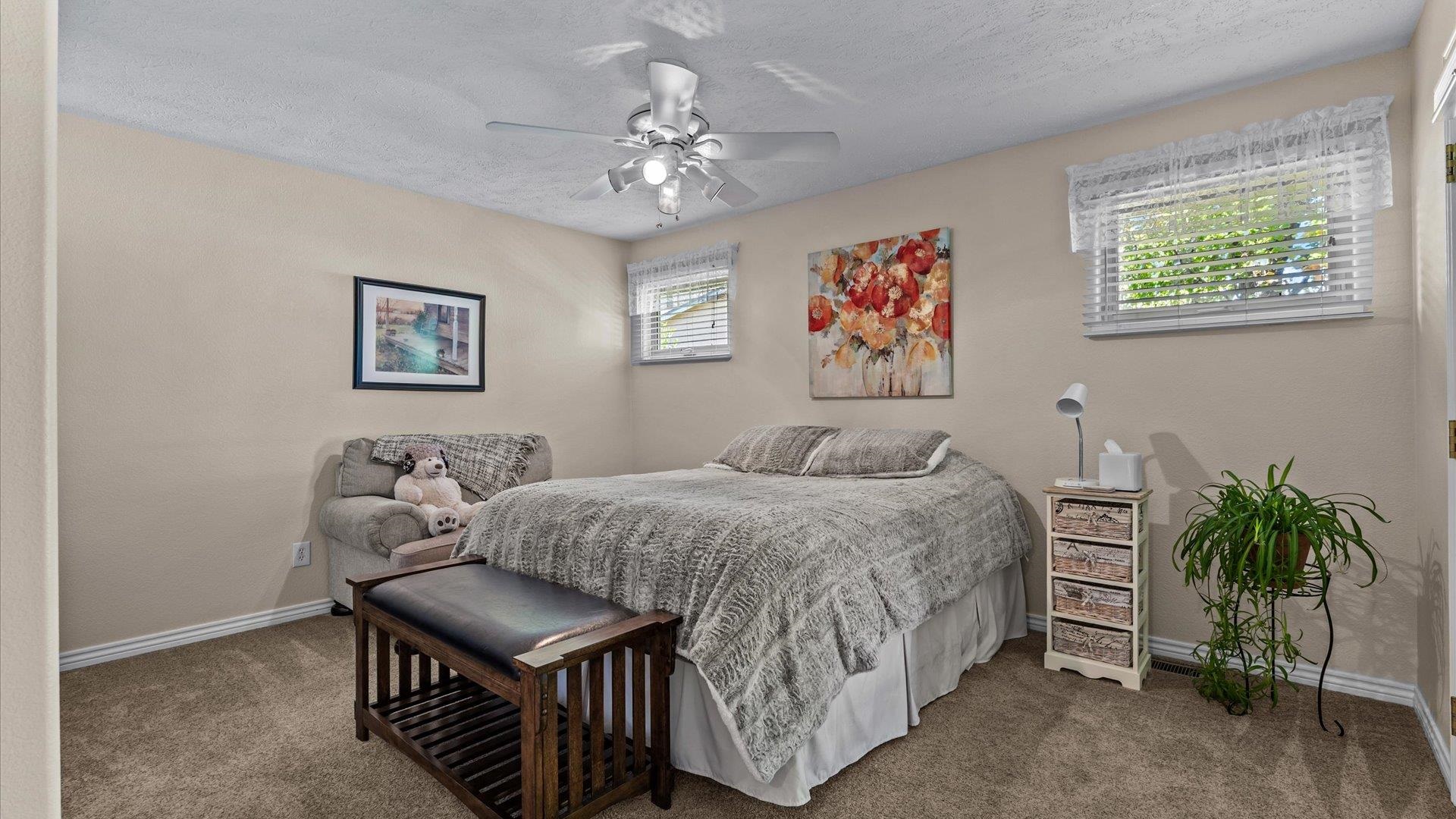 1355 Monument Court Fruita, CO 81521 - Photo 16 of 27 a bed room with a bed and a chandelier