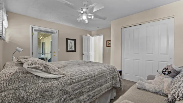 a bedroom with a bed and a chandelier