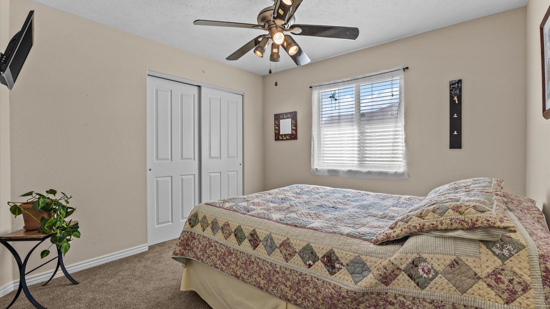 1355 Monument Court Fruita, CO 81521 - Photo 18 of 27 a bedroom with a bed and a window