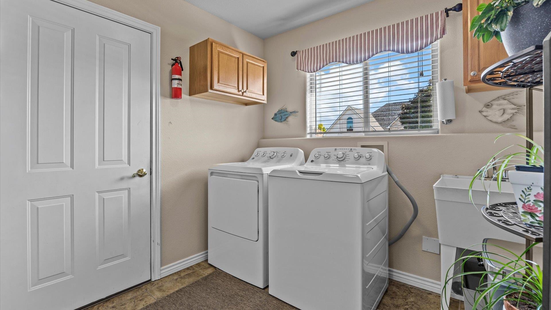 1355 Monument Court Fruita, CO 81521 - Photo 22 of 27 a utility room with a window dryer and washer