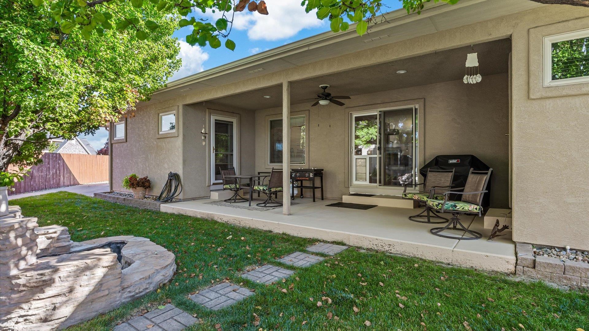 1355 Monument Court Fruita, CO 81521 - Photo 26 of 27 a view of a patio with table and chairs a barbeque