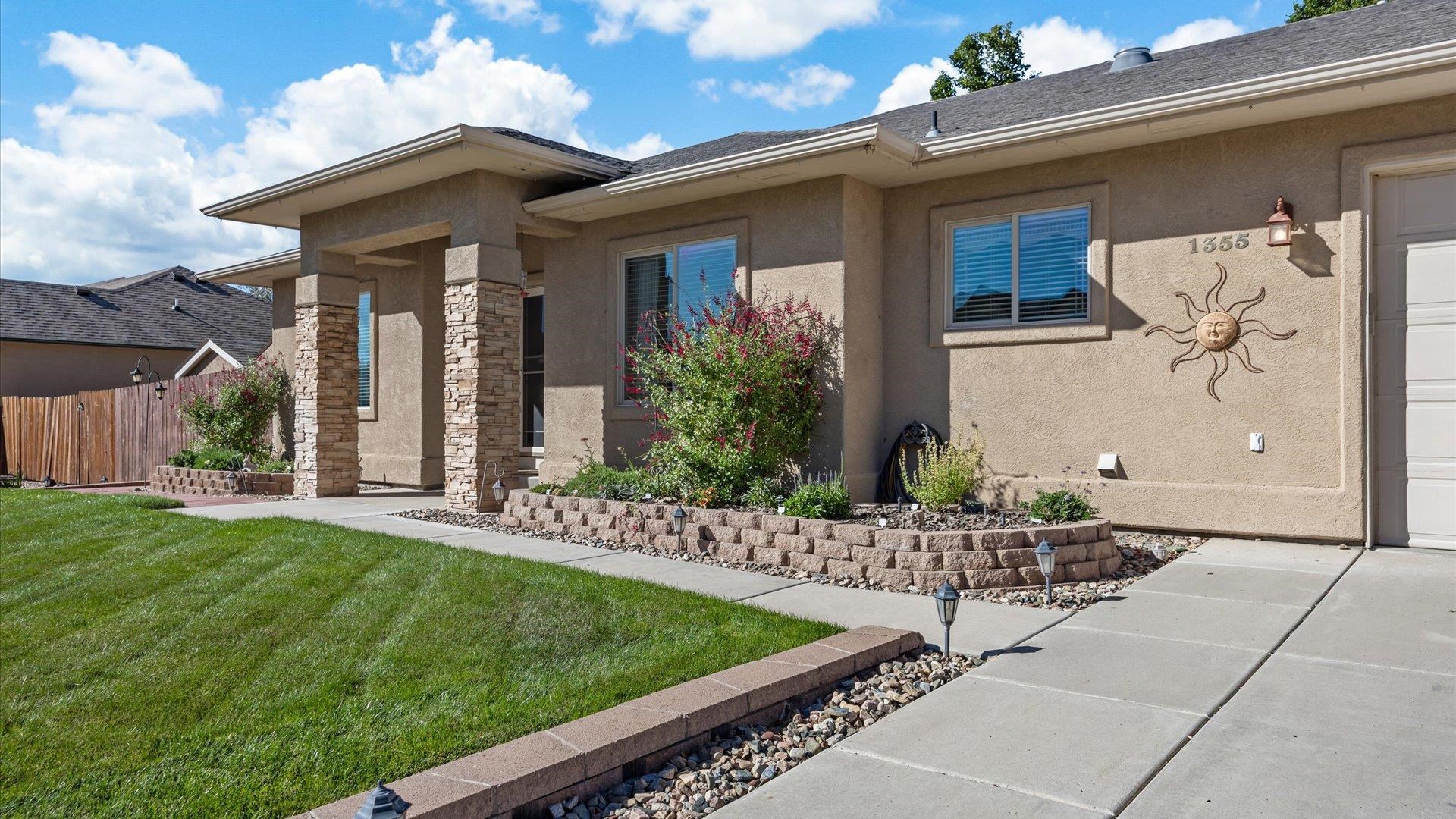 1355 Monument Court Fruita, CO 81521 - Photo 4 of 27 a front view of a house with garden