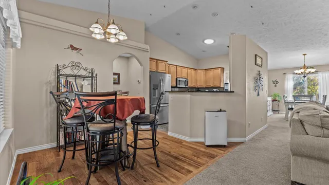 a view of a dining room with furniture and chandelier