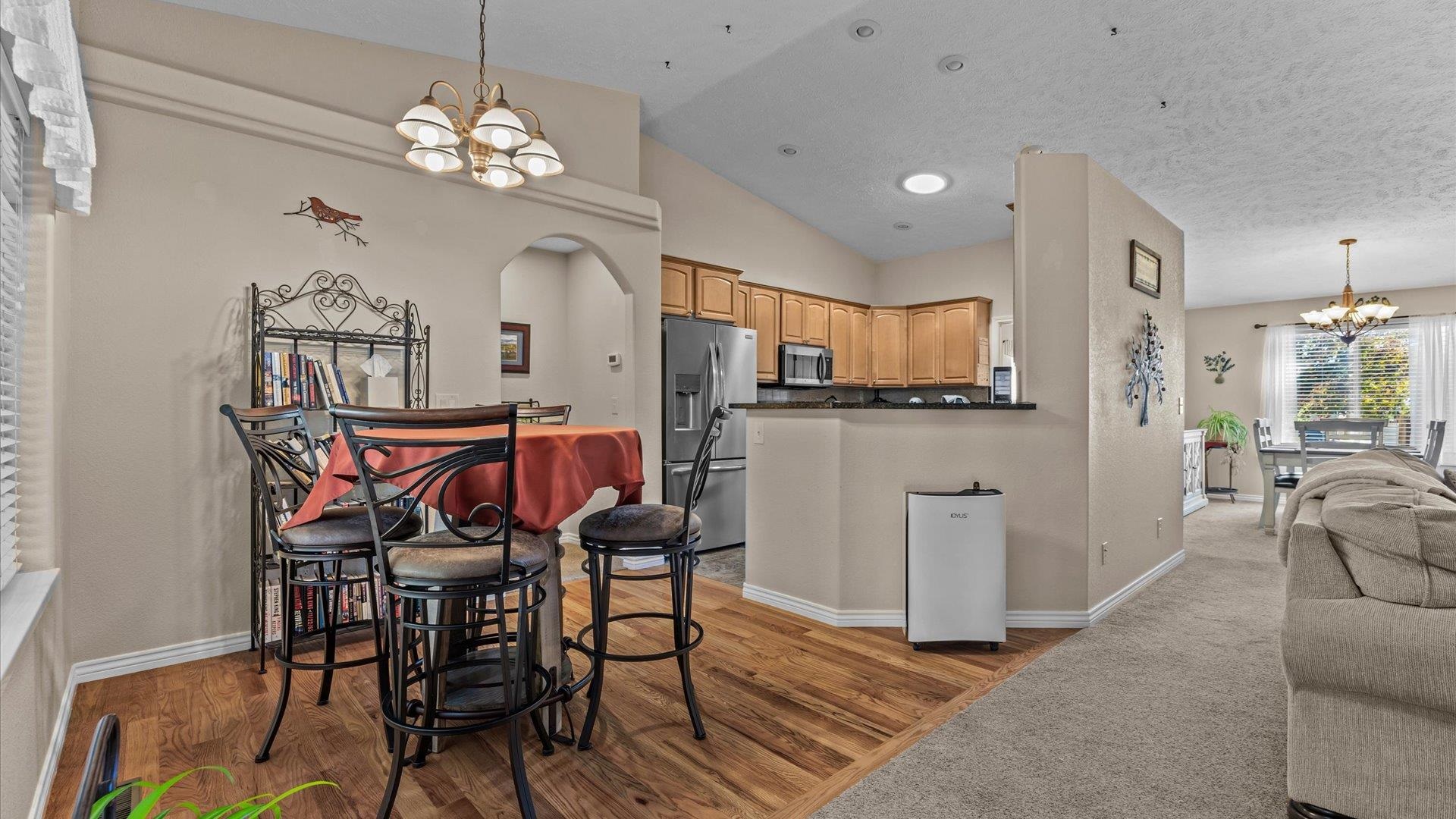 1355 Monument Court Fruita, CO 81521 - Photo 8 of 27 a view of a dining room with furniture and chandelier