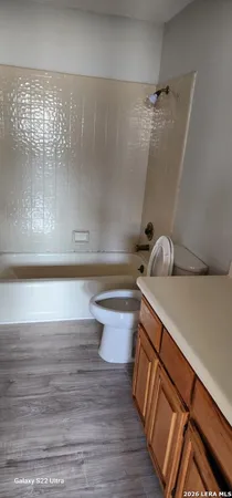 a bathroom with a shower and a toilet