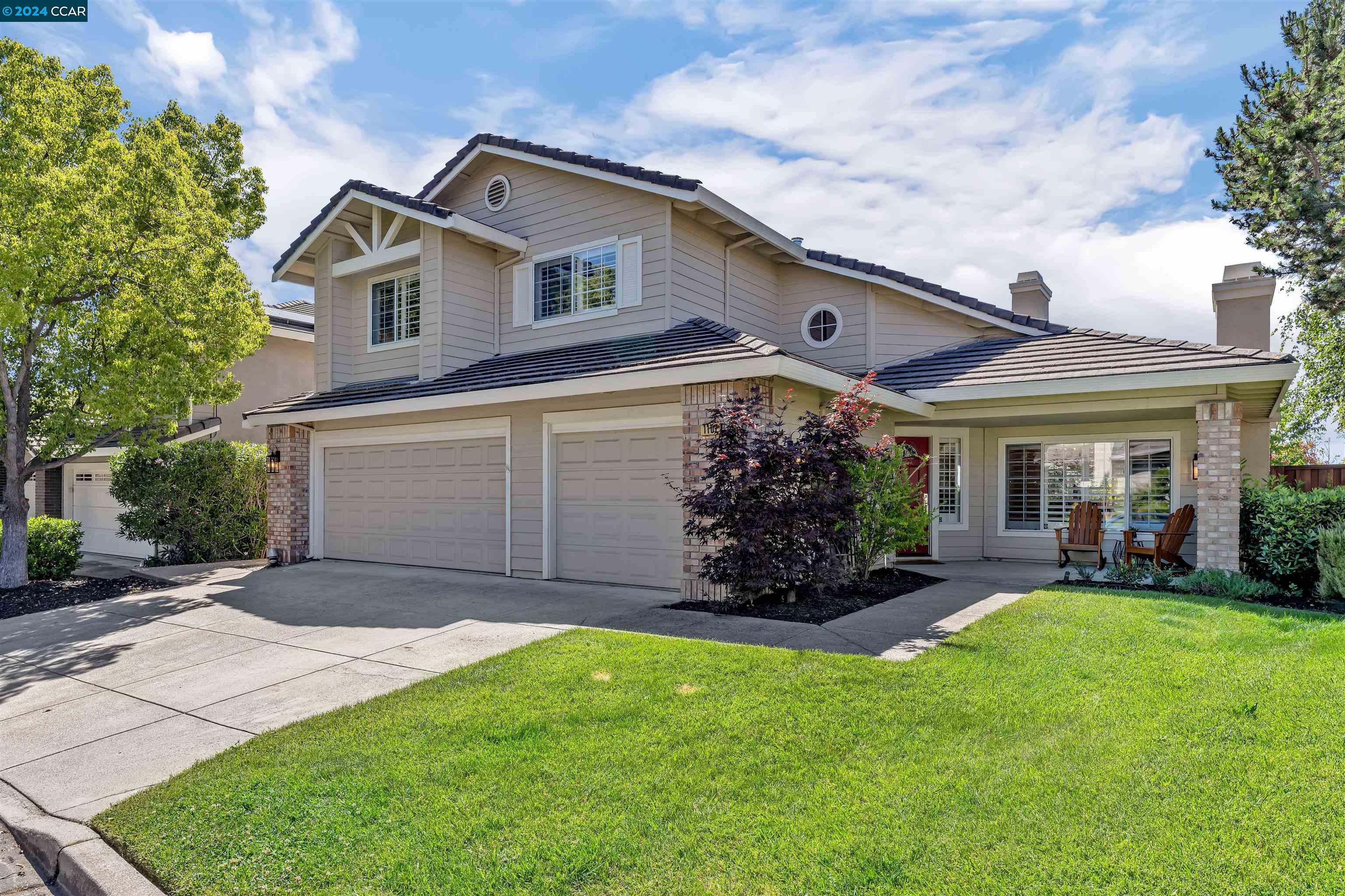 a front view of a house with a garden and plants