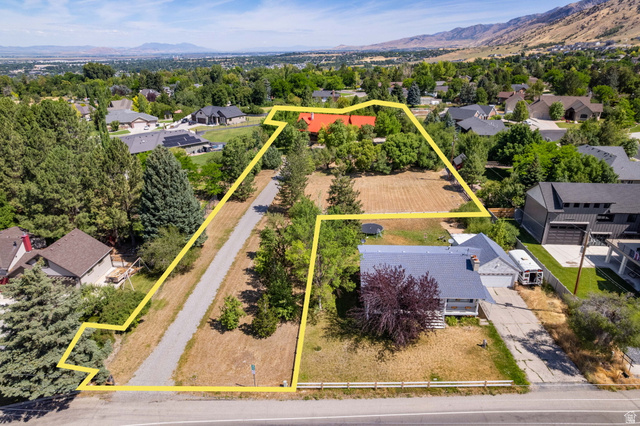 435 Canyon Road Millville, UT 84326 - Photo 109 of 113 Expansive property featuring a gravel driveway, mature trees, and a distant mountain backdrop