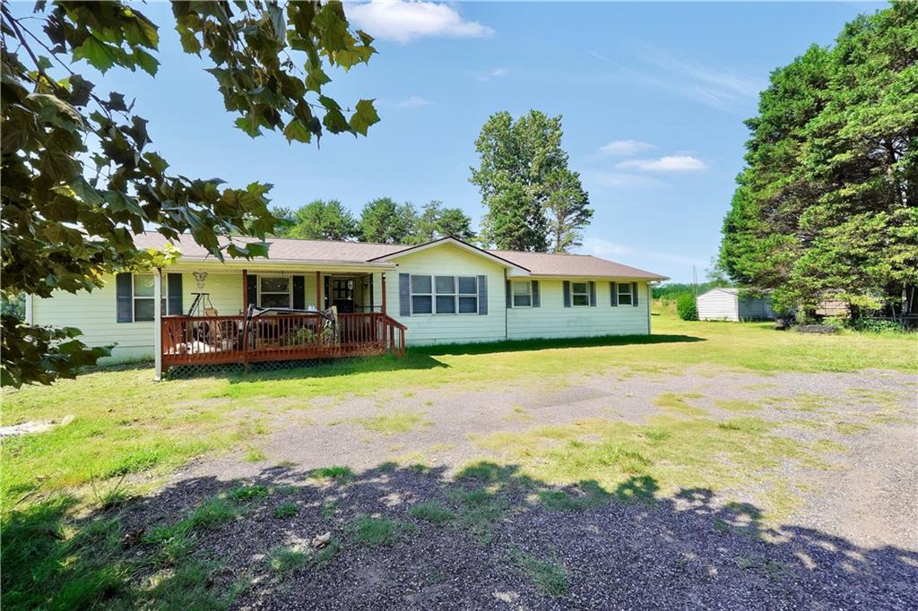a front view of a house with yard patio and swimming pool