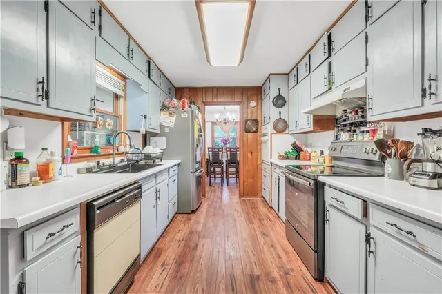 a dining room with furniture potted plants and wooden floor