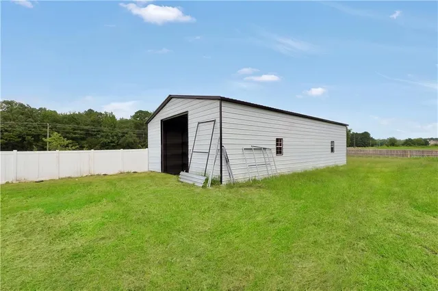 a backyard of a house with lots of green space and mountain view in back